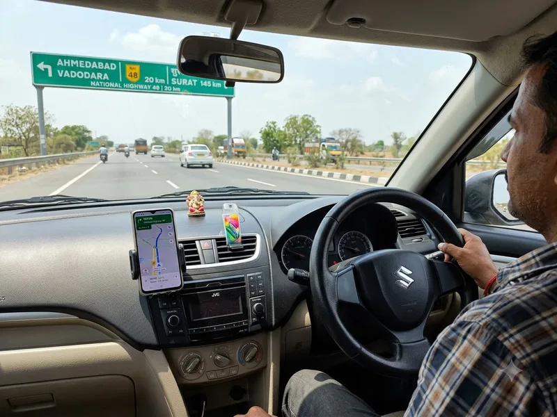 Dashboard detail with the route on a phone mount, road ahead blurred